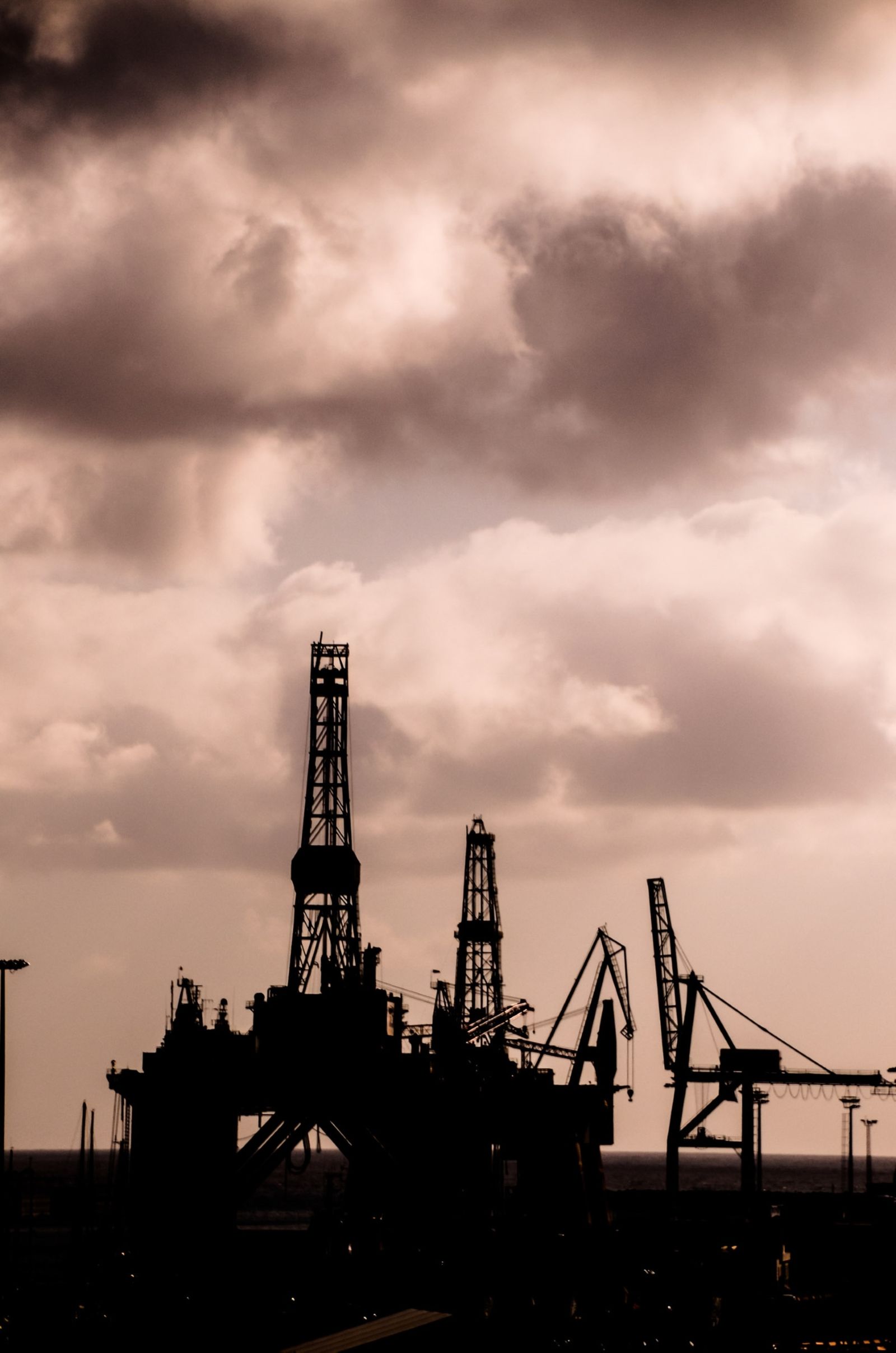Offshore platform silhouetted against a clouded sky